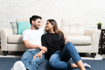 Obraz premium Smiling Latin Couple Relaxing At Home
