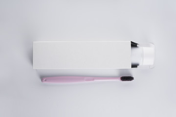 Flat lay composition of toothbrush and toothpaste on a white background