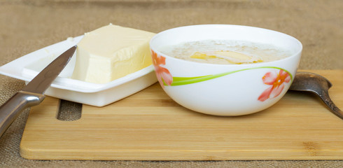 healthy eating concept. oatmeal porridge in milk and butter