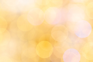 Gold bokeh background. Abstract glitter festive blur lights. Soft yellow christmas backdrop.