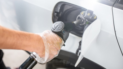 car refueling - petrol station - glove - hygiene