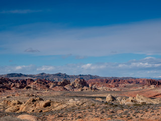 Blue sky over a road through beautiful rugged desert terrain at Valley of Fire State Park, Nevada, USA.