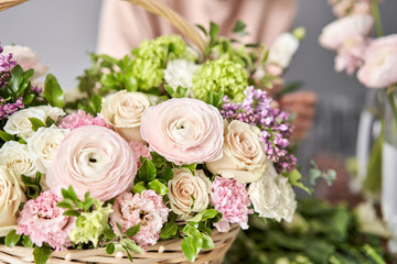 Spring bouquet in a wicker basket.. Learning flower arranging, making beautiful bouquets with your...