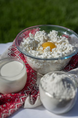 Fresh homemade cottage cheese, milk and eggs. Ingredients for cottage cheese pancakes with oats. Dairy products. Healthy breakfast.