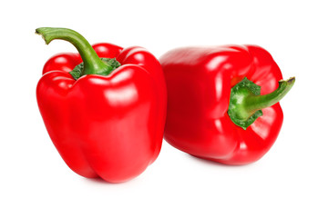 two red sweet bell peppers isolated on white background