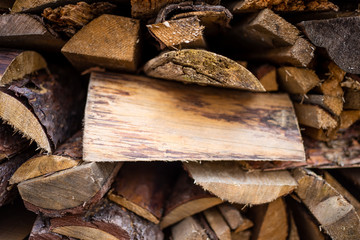 chopped dry firewood cooked for the fireplace and stove lying in a heap one on one on the street. Ready to Burn in Fireplace