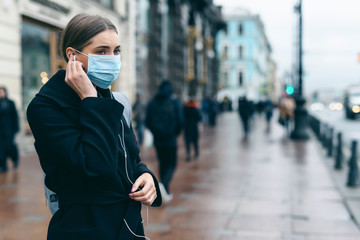 Prevention of coronavirus outbreak in 2020. Portrait of young european woman wearing a mask in the...