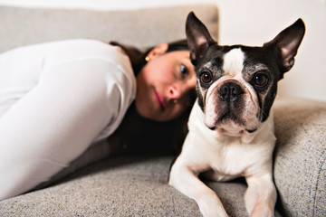 Woman with is Boston Terrier on the living room