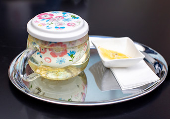 A cup of jasmine tea with lemon and honey