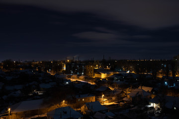 Lights of the night city. The streets are lit by yellow lanterns.