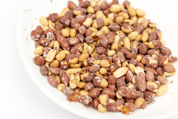 Fried Salty Peanut served in the white bowl above white background