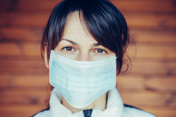 COVID-19 Pandemic Coronavirus Woman in city street wearing face mask protective