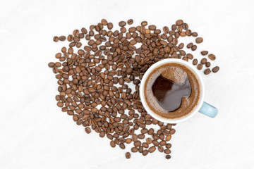 Cup Of Black Coffee With Coffee Beans On The White Table