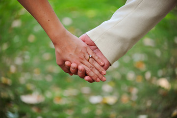 Close up of an elegant engagement diamond ring on woman finger. love and wedding concept