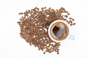 Cup Of Black Coffee With Coffee Beans On The White Table