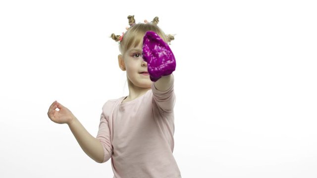 Kid playing with hand made toy slime. Child having fun making purple slime