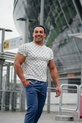 A sports guy stands and enjoys a walk near the stadium. Lifestyle