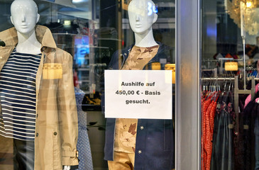 Job offer in German letters on a sign in a shop window.