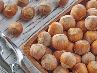 Hazelnuts lie on light wooden boards.Useful hazelnut for health.