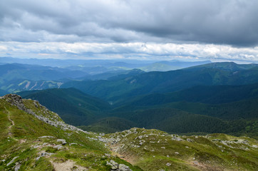 Obraz premium Beautiful view of the mountain range Chornohora with its spurs in the Carpathian Mountains with cloudy sky in summer, Ukraine 