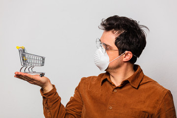 Style man in glasses and face mask holds shopping cart © Masson