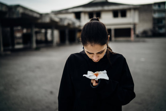 Sick woman holding bloody tissue.Cough with blood.Infectious disease victim.Ill person having lethal respiratory disease.Attacked immune system.Symptoms of severe tissue damage.Viral fever