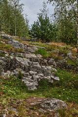 Fototapeta na wymiar Panorama of Karelian nature from a height.Panoramic view of the surroundings of Sortavala from a hill in a city park: a forest of conifers, traces of volcanic lava, rocks and volcanic rocks. Russia