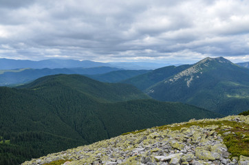 Summer Carpathian mountain top view from stony ridge to Dovbushanka mount. Gorgany, Ukraine 