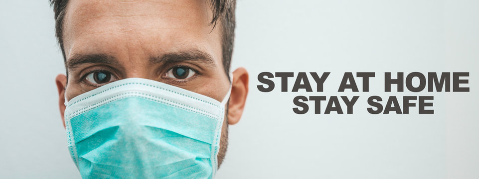 Portrait of a sick man wearing a mask with text "Stay at home" "Stay safe". Coronavirus concept
