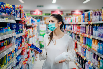Woman wearing protective mask preparing for virus pandemic spread quarantine.Hygiene, cleaning and...