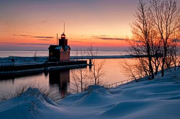 The Holland Harbor South Pierhead Lighthouse, also known as Big Red, stands guard on the icy shore...