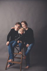 Sweet children, boy brothers in black sweaters, listening music