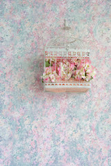 hydrangea flowers and decorative cage on a delicate pink-blue background. Interior decoration in soft colors.