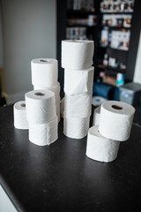 Toilet paper bunched up together on a counter in a home