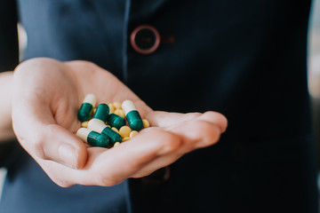 Medicine pills or capsules in hand. Pharmaceutical medicament. Antibiotic, painkiller closeup....