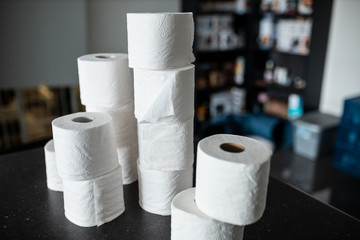 Toilet paper bunched up together on a counter in a home