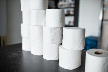 Toilet paper bunched up together on a counter in a home