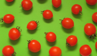 Tomatoes cherry on green background.