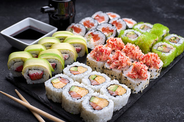 Sushi set, on a black background, five types of rolls