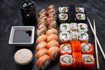 Sushi set, on a black background, five types of rolls