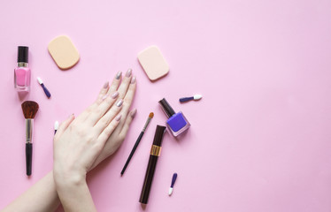 Beautiful woman's hands on pastel pink background. Nature Cosmetics for skin care and makeup accessories.