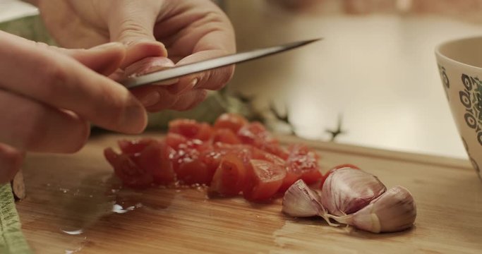 Cutting onion and tomatoes on a chopping board