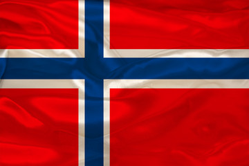 Naklejka premium beautiful photo of the colored national flag of the modern state of Norway on textured fabric, concept of tourism, emigration, economics and politics, close up