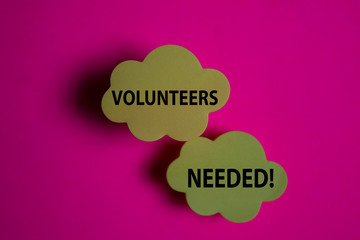 Volunteers Needed! write on a sticky note isolated on Office Desk.