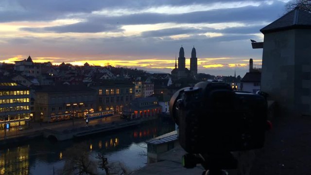 DSLR camera on tripod taking timelapse pictures of sunset / sunrise over the city