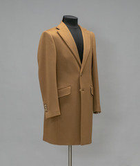 Beige coat on a mannequin in the studio