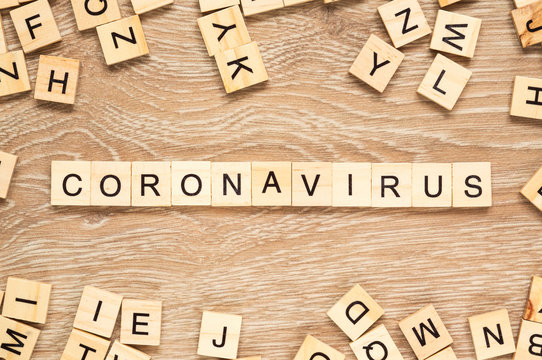 The word "Coronavirus" spelt out with letter tiles on the wooden background