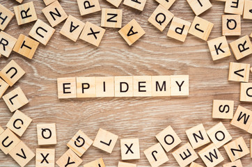 The word "Epidemy" spelt out with letter tiles on the wooden background