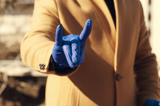 Man putting on medical gloves for protection from Coronavirus