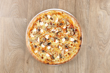 chicken pizza with vegetables on a wooden background